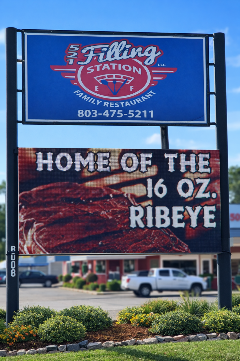 Restaurant sign reads: HOME OF THE 16 OZ. RIBEYE with an image of a steak and contact information above.
